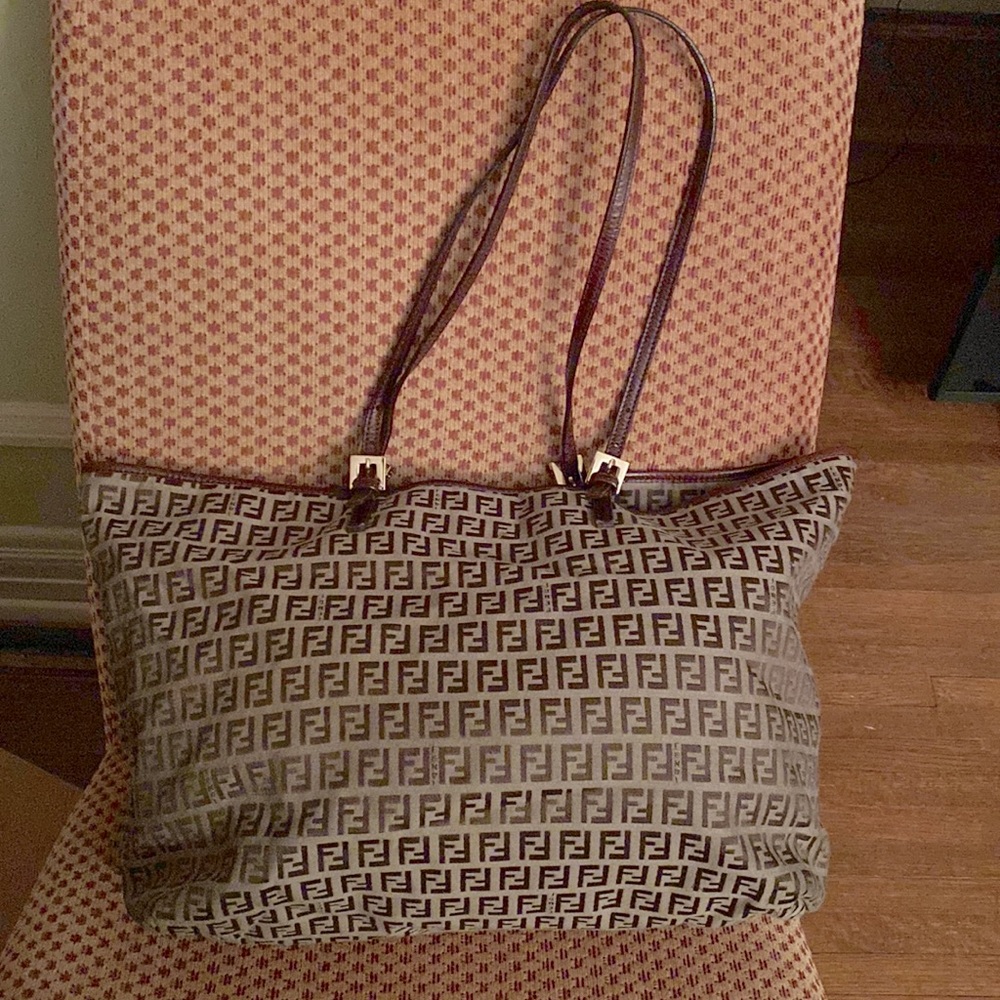 Iconic FENDI leather trimmed canvas tote bag for sale.